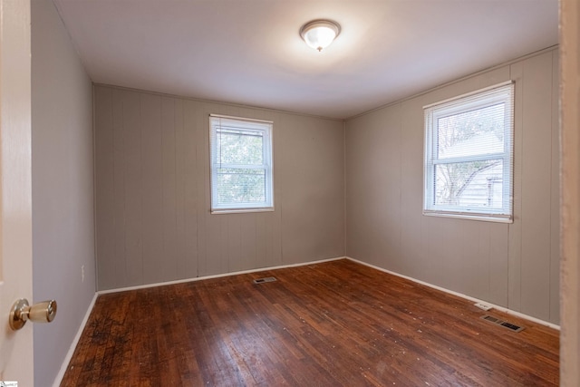 empty room with dark hardwood / wood-style floors