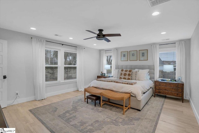 bedroom with light hardwood / wood-style flooring and ceiling fan