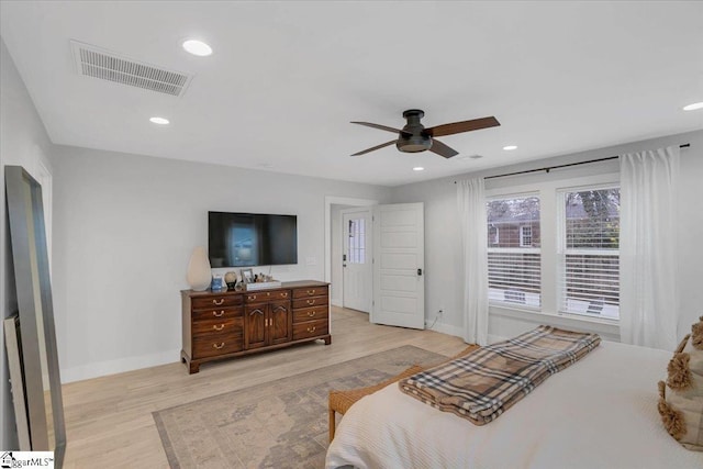 bedroom with ceiling fan and light hardwood / wood-style floors