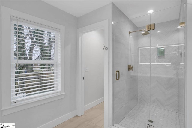 bathroom featuring a shower with shower door