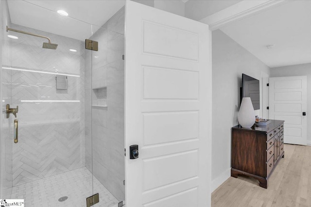 bathroom featuring an enclosed shower and wood-type flooring