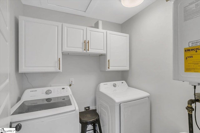 laundry area featuring independent washer and dryer and cabinets