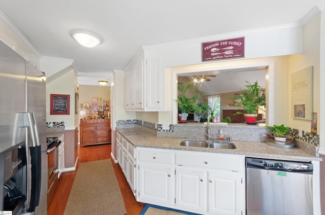 kitchen with stainless steel appliances, crown molding, sink, and white cabinets