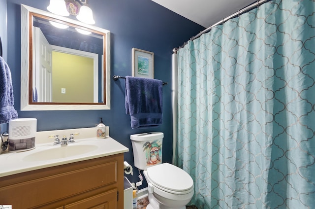 bathroom featuring walk in shower, vanity, and toilet