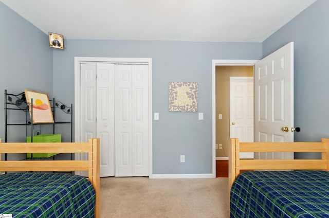 bedroom featuring light colored carpet and a closet