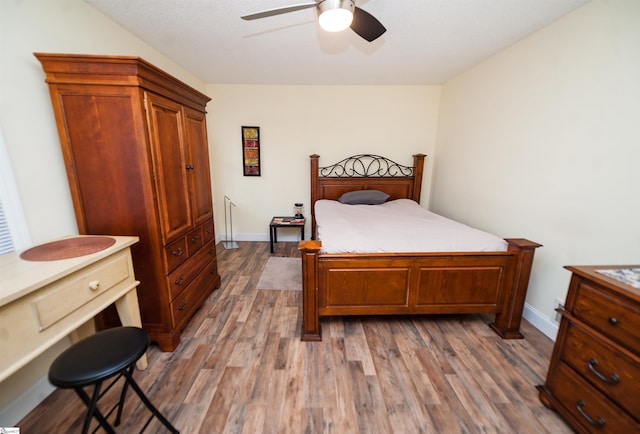 bedroom with ceiling fan and dark hardwood / wood-style flooring