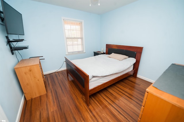 bedroom with dark wood-type flooring