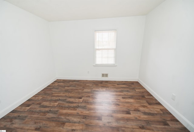 empty room with dark wood-type flooring