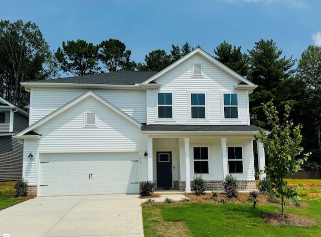 view of front of house with a garage and a front yard