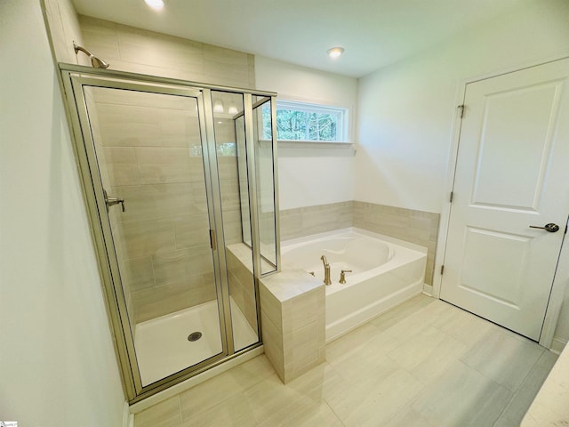 bathroom featuring separate shower and tub