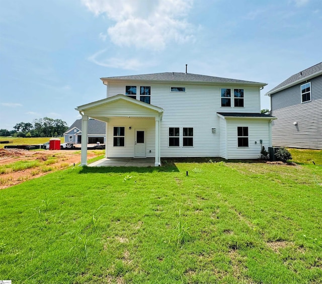 back of house featuring a yard and a patio area