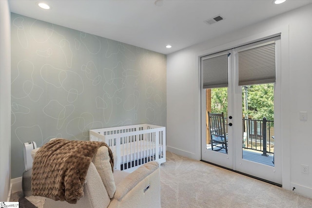 bedroom with access to outside, light carpet, and french doors