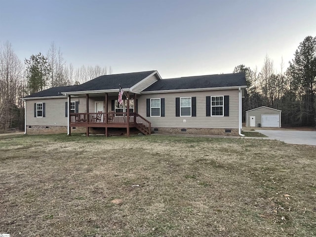 view of front of house with an outbuilding, a garage, a front lawn, and covered porch