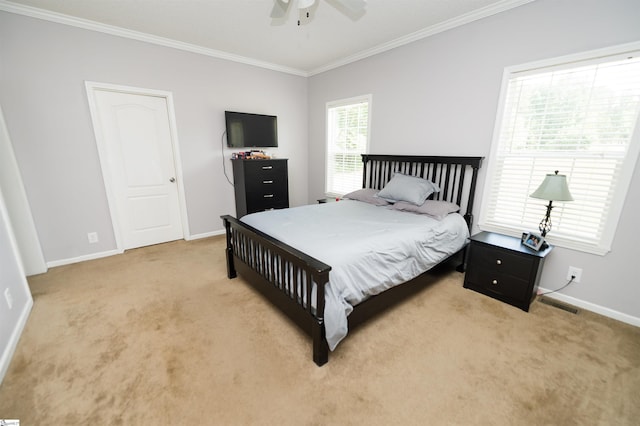 bedroom with ceiling fan, ornamental molding, and light carpet