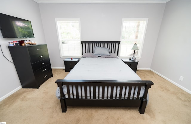 carpeted bedroom with multiple windows and crown molding