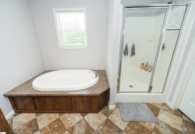 bathroom featuring independent shower and bath