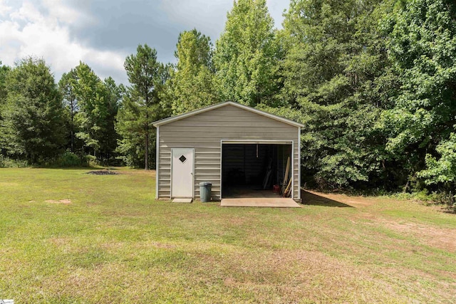 view of outbuilding featuring a garage and a lawn