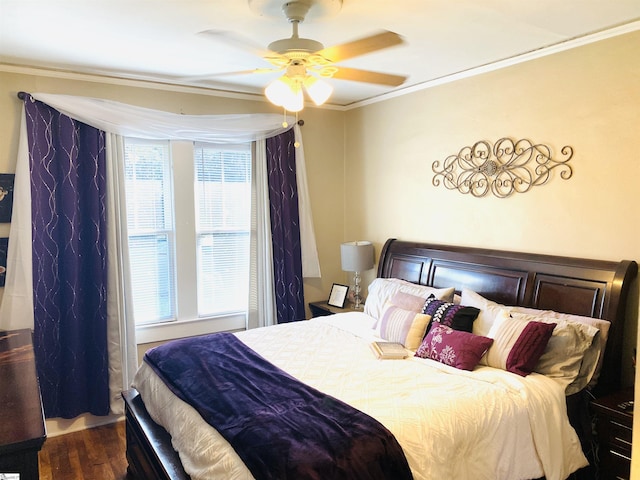 bedroom featuring hardwood / wood-style flooring, ceiling fan, ornamental molding, and multiple windows