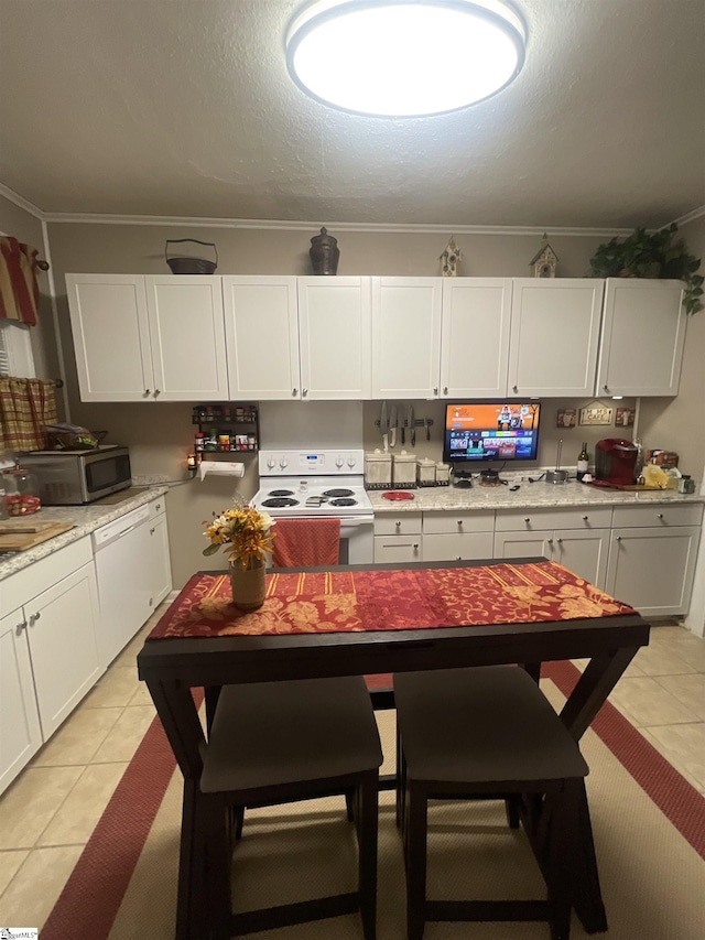 kitchen featuring crown molding, light tile patterned floors, white appliances, and white cabinets