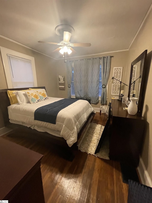 bedroom featuring dark hardwood / wood-style flooring, crown molding, and ceiling fan