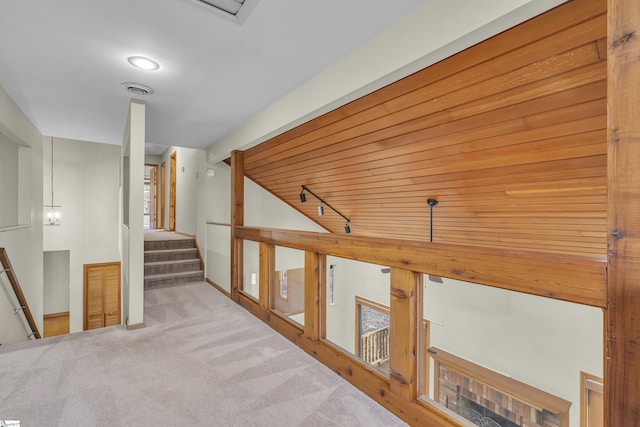 corridor with light carpet and track lighting