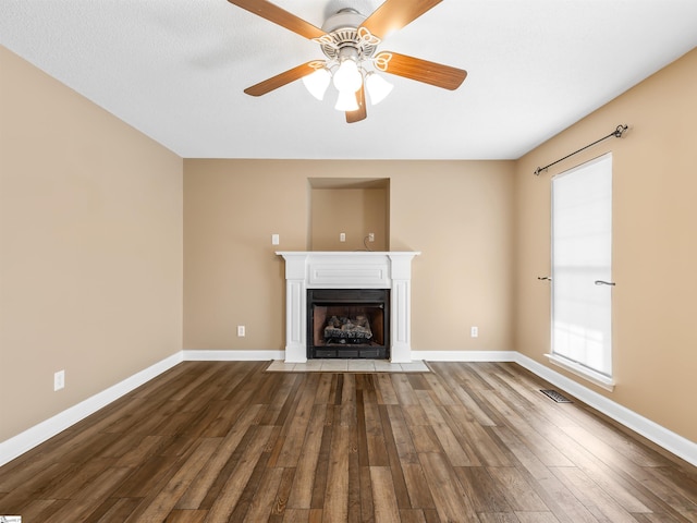 unfurnished living room featuring wood-type flooring and ceiling fan