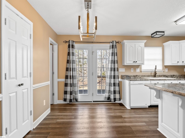 kitchen featuring dishwasher, sink, white cabinets, and dark hardwood / wood-style flooring