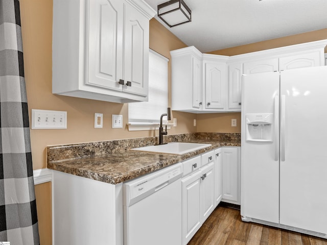 kitchen featuring sink, white appliances, dark hardwood / wood-style floors, and white cabinets