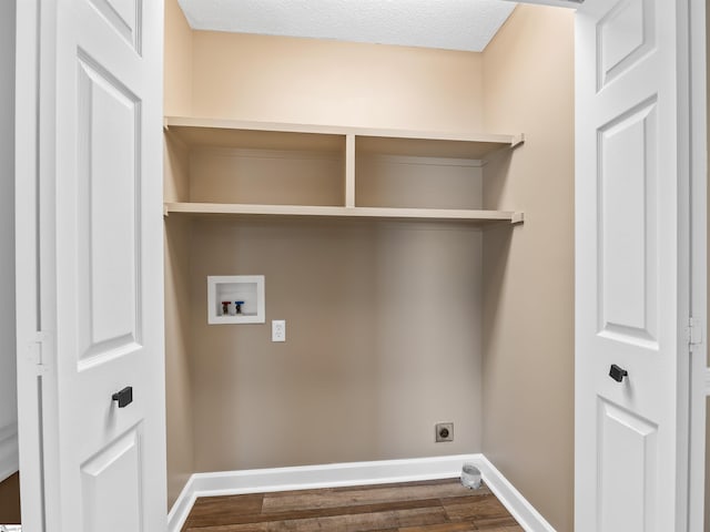 clothes washing area featuring dark wood-type flooring, washer hookup, a textured ceiling, and electric dryer hookup