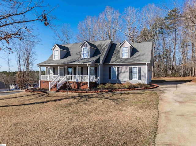 cape cod home with a front yard and a porch