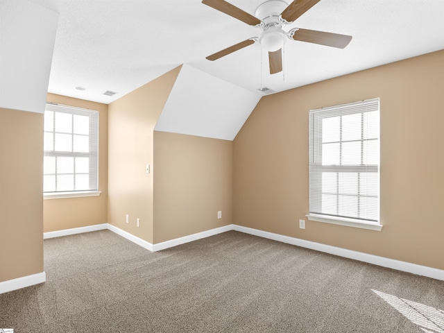 bonus room featuring lofted ceiling, carpet floors, and ceiling fan