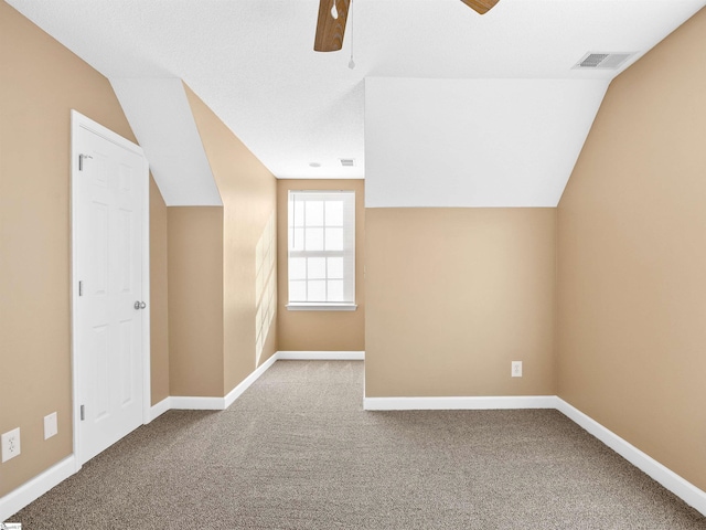 additional living space featuring ceiling fan, vaulted ceiling, and carpet