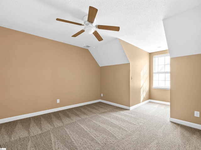 bonus room with lofted ceiling, ceiling fan, a textured ceiling, and carpet