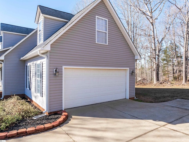 view of side of property with a garage