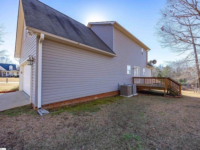 view of property exterior with a wooden deck, a garage, and central air condition unit