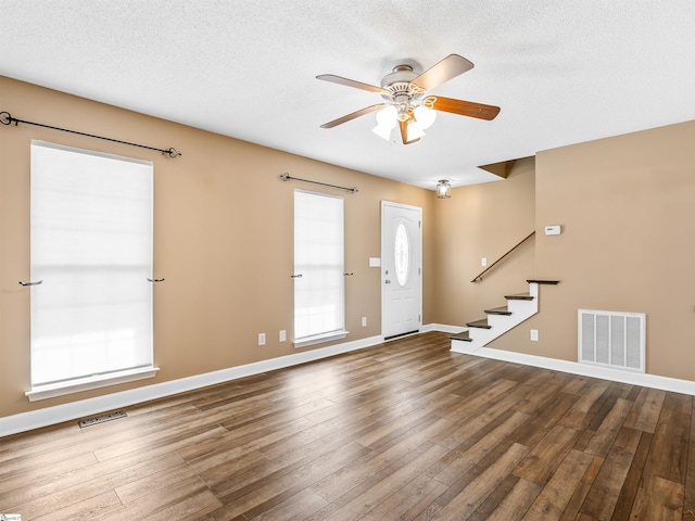 interior space featuring ceiling fan, hardwood / wood-style floors, and a textured ceiling