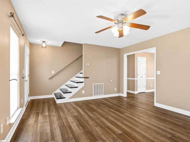 unfurnished room with ceiling fan and dark hardwood / wood-style flooring