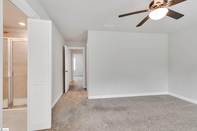 spare room featuring light carpet and ceiling fan