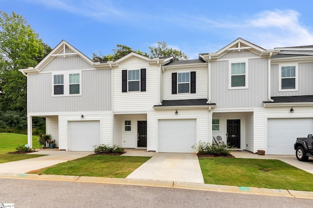 view of property with a garage and a front yard