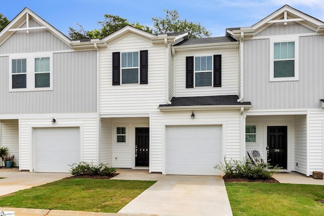 multi unit property featuring a garage and a front yard