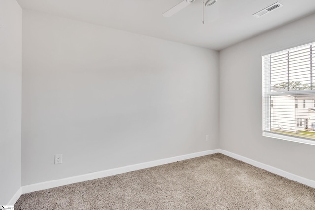 spare room with ceiling fan and carpet