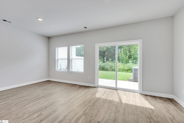 spare room with light hardwood / wood-style floors