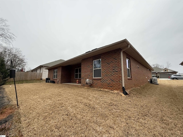 view of side of home featuring a yard