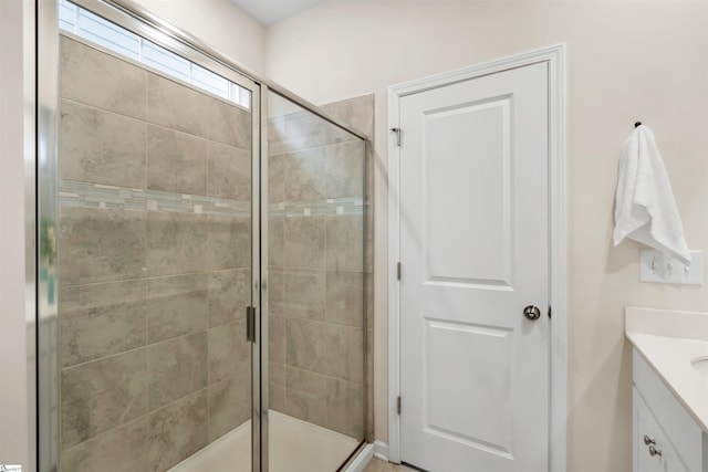 bathroom with walk in shower and vanity