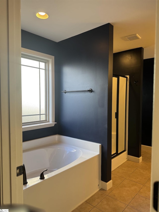 bathroom featuring tile patterned flooring and separate shower and tub