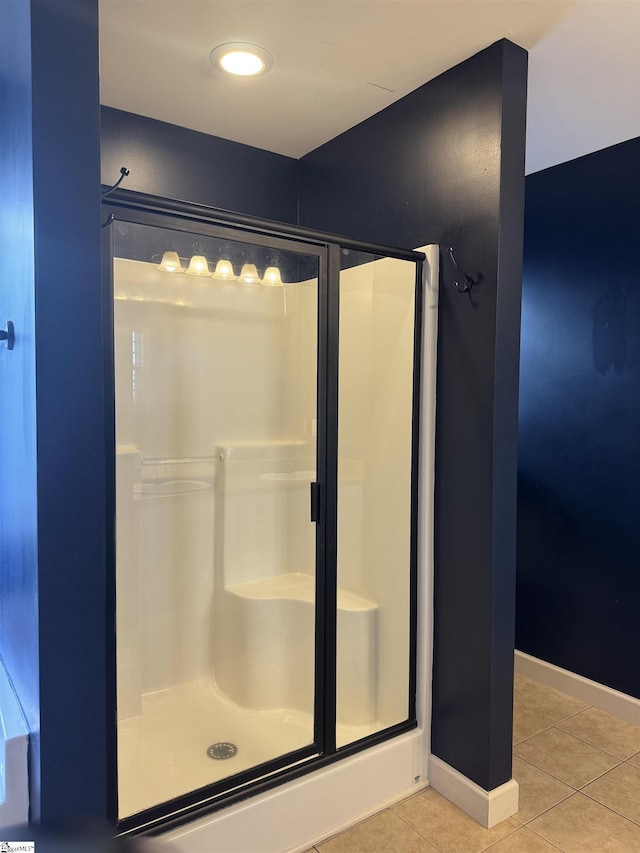 bathroom with walk in shower and tile patterned floors