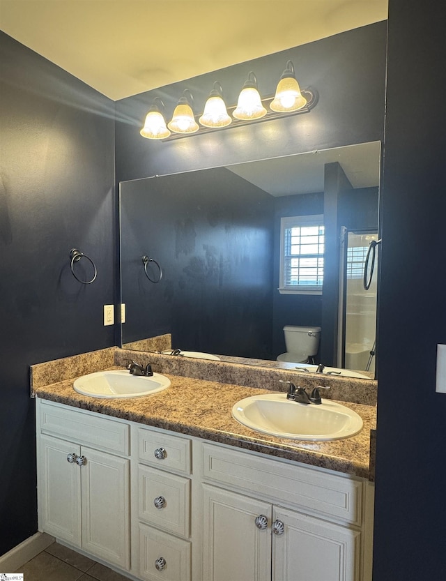 bathroom featuring tile patterned floors, vanity, and toilet