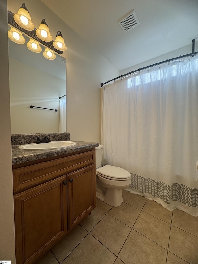 bathroom with vanity, tile patterned floors, and toilet