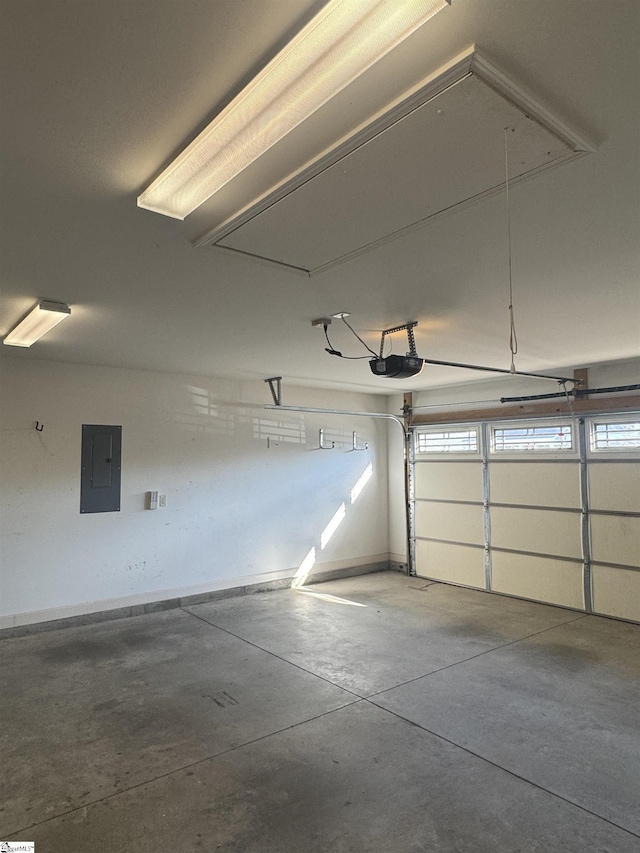 garage with a garage door opener and electric panel