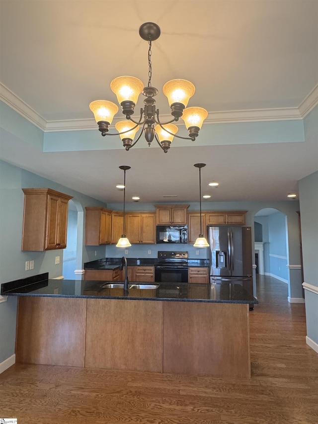 kitchen featuring sink, pendant lighting, and black appliances